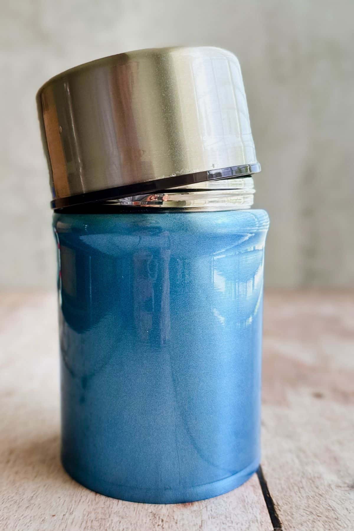 picture of a blue thermos on a table.
