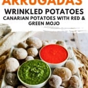 Graphic reads “Papas Arrugadas – Wrinkled Potatoes with Red & Green Mojo” above a plate of salt-crusted potatoes with red and green sauces.