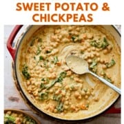 Overhead of creamy sweet potato and chickpea stew in a red pot with kale and a silver spoon, with text reading “How to Make Creamy Sweet Potato & Chickpeas.”