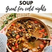 Bowl of mushroom barley soup with text overlay "How to Make Mushroom Barley Soup Great for cold nights" held over a woven placemat.