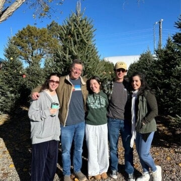 Pearce family photo in front of Christmas tree.