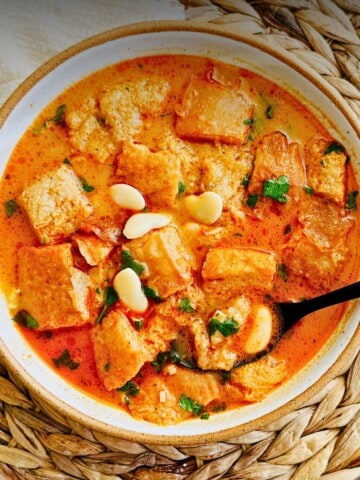 Bowl of Spanish garlic soup (sopa de ajo) with a spoon in the bowl.