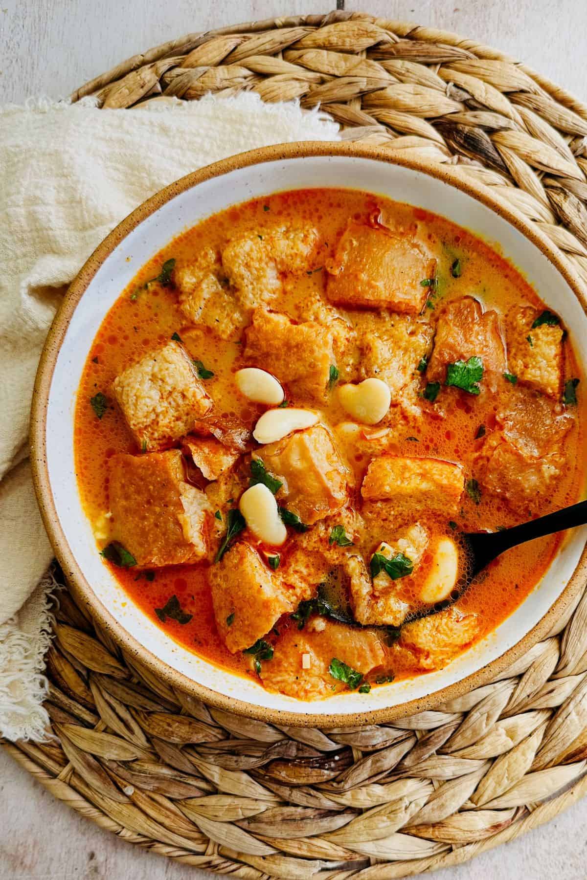 Vegan Spanish garlic soup (sopa de ajo)  served in a white bowl.