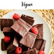 Pinterest-style graphic reading “How to Make Chocolate Fudge (Vegan)” above a plate of rich vegan chocolate fudge squares garnished with fresh raspberries.