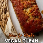 Vegan Cuban pudín de pan bread pudding loaf with a glossy caramel top on a white plate, with text overlay reading "How to Make Vegan Cuban Pudín de Pan (Bread Pudding)."