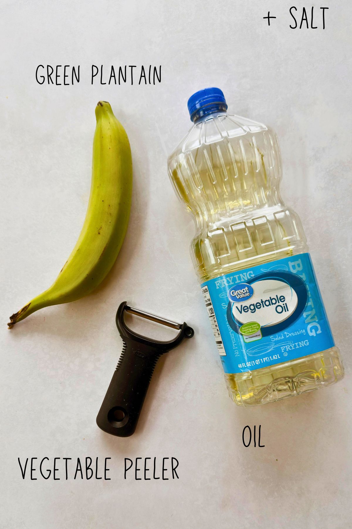 Ingredients and tool for making mariquitas: a green plantain, vegetable oil, a Y-peeler, and salt.
