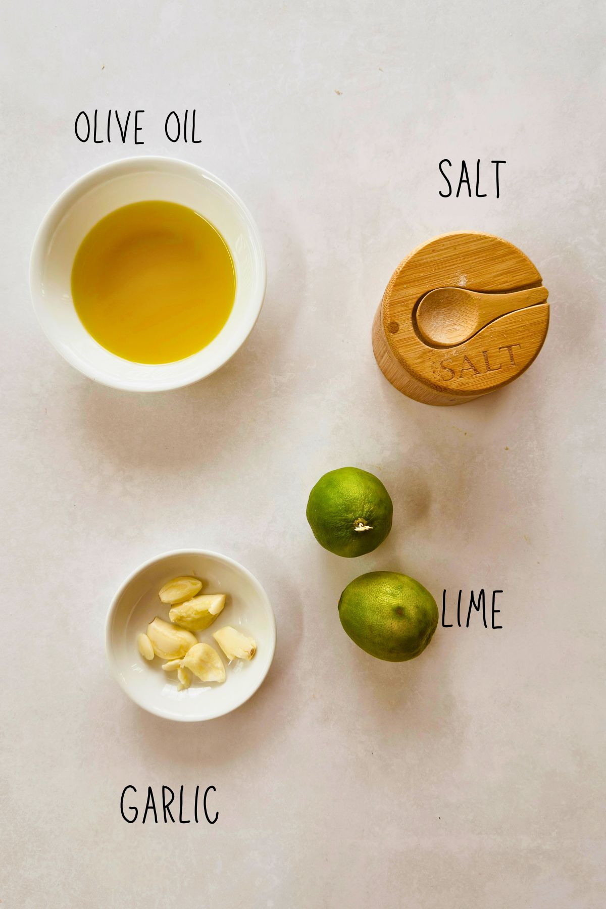 Ingredients for simple mojo: olive oil, salt, garlic cloves, and limes.