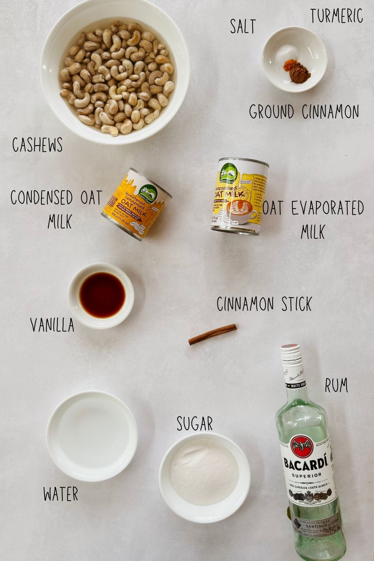 Ingredients for vegan crema de vie: cashews, oat condensed and evaporated milks, vanilla, cinnamon, turmeric, sugar, water, salt, and white rum.