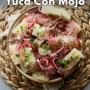 Pinterest graphic reading ‘How to Make Yuca Con Mojo - Easy to Make!’ over a bowl of yuca with pink onions and parsley.